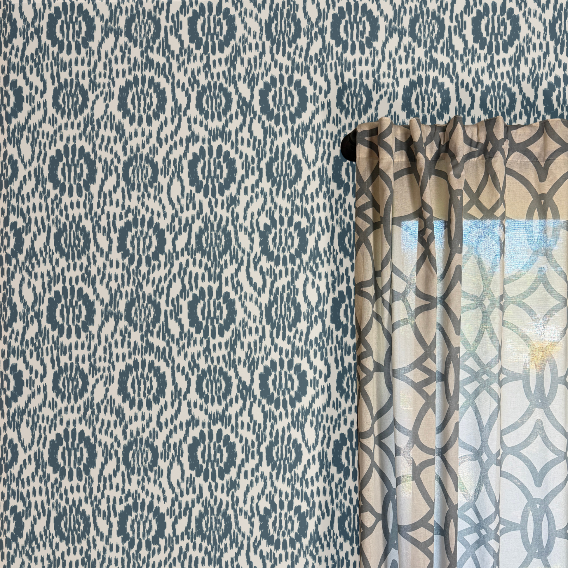 Patterned curtain with geometric design against a coordinating wallpaper.